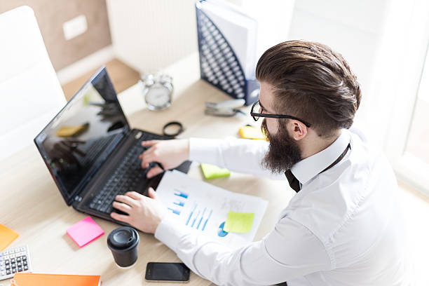 istock Business man in office from above 473786116