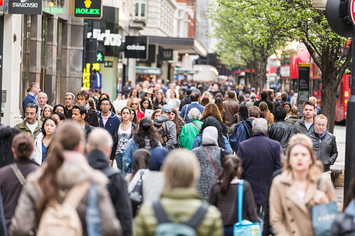 London, United Kingdom - April 17, 2015: Crowded sidewalk on Oxford Street with commuters and tourists from all over the world.