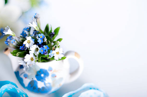 Books and wildflowers on napkin on wooden table on wooden wall background