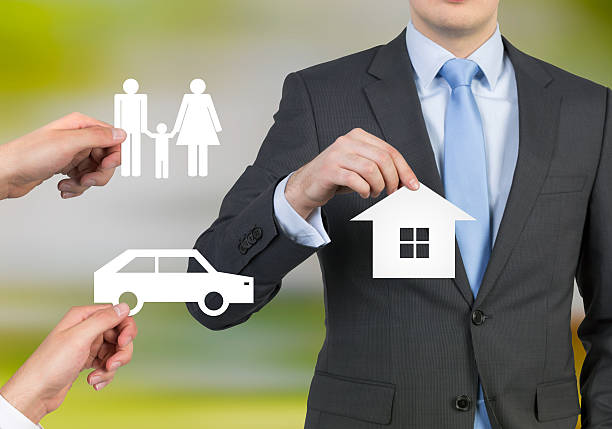istock businessman holding house 473791408