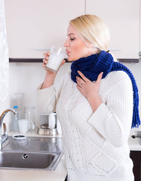 istock Young woman doing oral rinsing 473795102