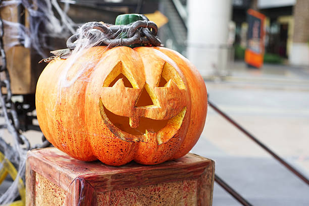 istock halloween scary pumpkin on wooden box 473795668