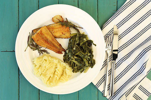 istock Grilled Smoked Haddock Fillet, Mash Potato, Swiss Chard on White 473796010