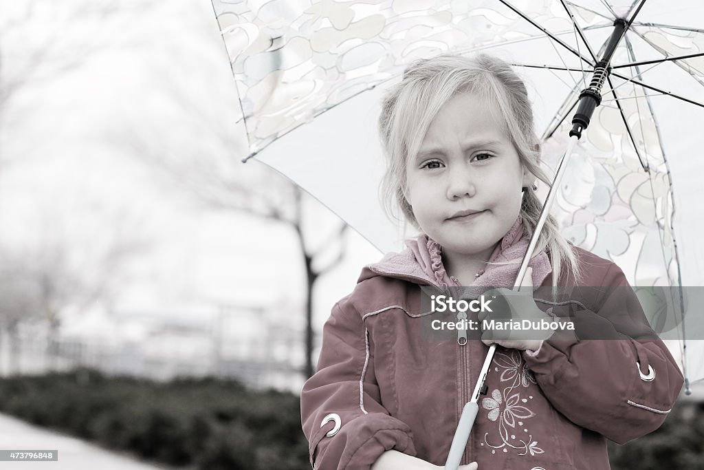 adorable blonde girl holding colorful umbrella walking in the st adorable blonde girl holding colorful umbrella walking in the street 2015 Stock Photo