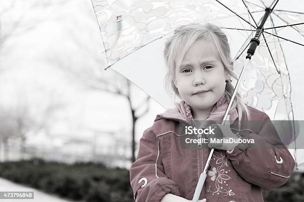 Adorable Blonde Girl Holding Colorful Umbrella Walking In The St Stock Photo - Download Image Now