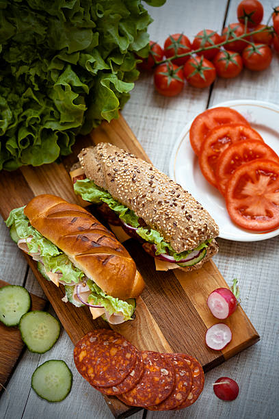 group of tasty sandwiches on a wooden table 