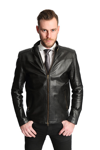 Attractive man wearing a white shirt, black tie and a black leather jacket. White background.