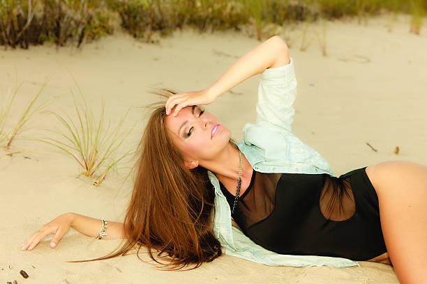 istock adorable girl lying on sandy beach 473801518
