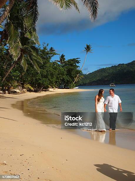 Bride Groom Holding Hands Walking The Beach In Fiji Stock Photo - Download Image Now