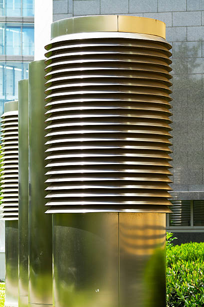 Huge metal air conditioner chimneys behind office building in Germany