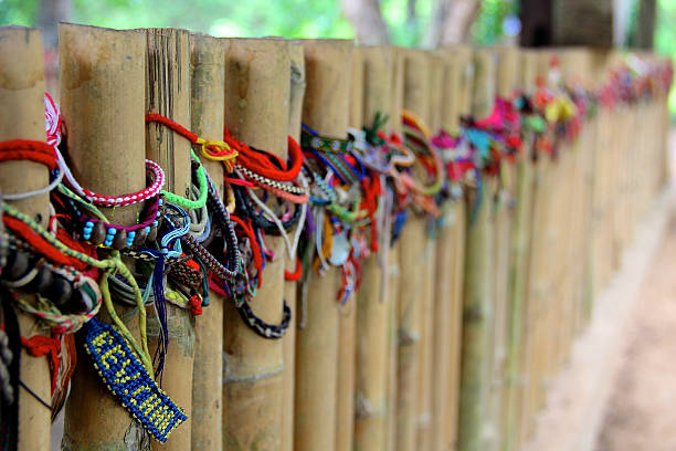 Arranged on the bamboo bars that surround the old mass grave, bracelets transcribe a message of support to the numerous victims of the red Khmers. 