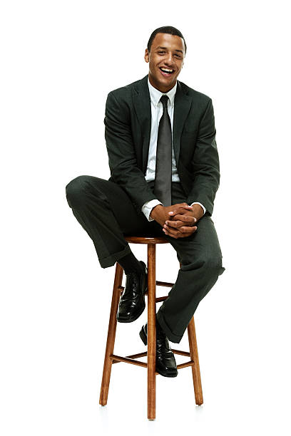 istock Cheerful businessman sitting on stool 473814874