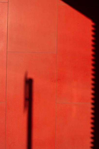 istock Shadow of Sign on Red Wall 473815972