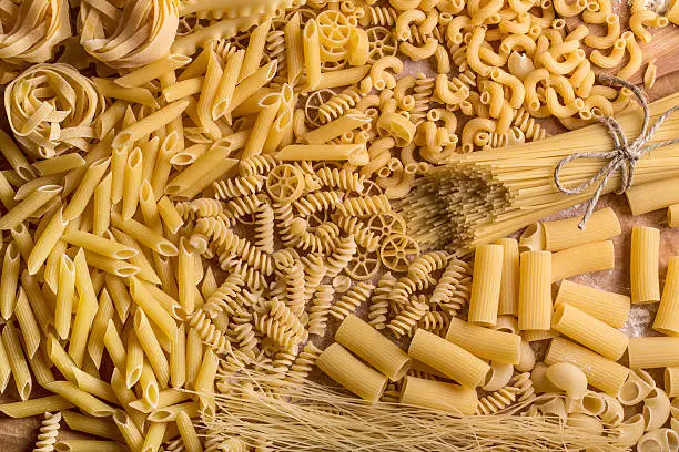 Variety of types and shapes of dry pasta