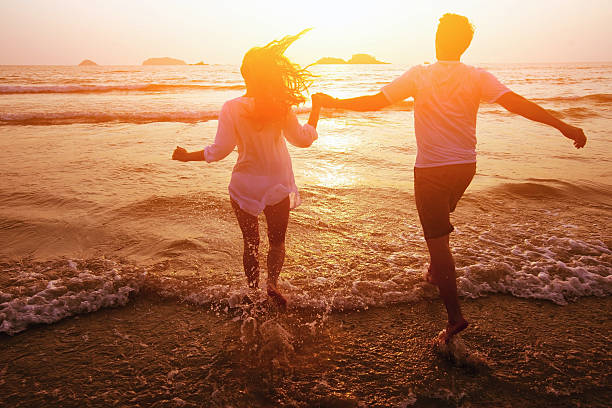 istock happy couple on the beach 473822358