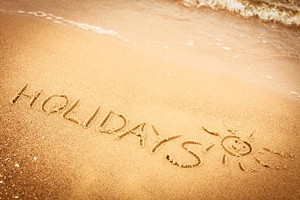 istock The word holidays written in the sand on a beach 473822650