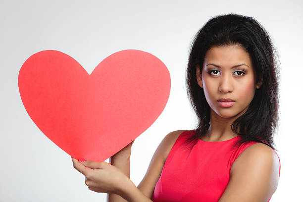 istock Girl mixed race with paper red heart 473822676