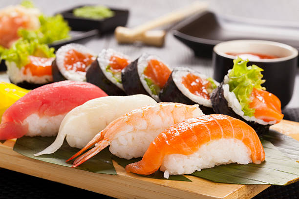 The composition of nigiri sushi The composition of nigiri sushi with tuna, salmon, shrimp, butterfish on rice wasabi sauce stock pictures, royalty-free photos & images