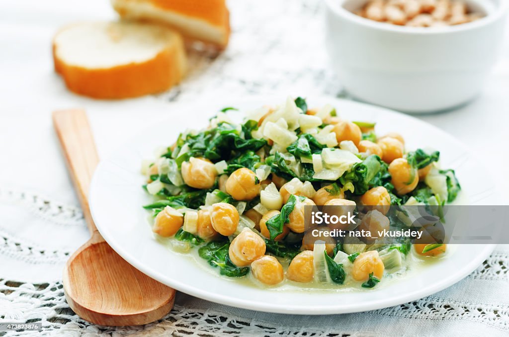 chickpeas and spinach curry chickpeas and spinach curry on a white background. the toning. selective focus Chick-Pea Stock Photo