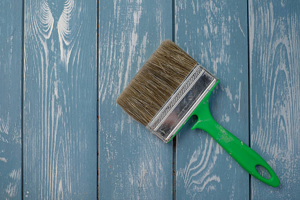 istock Paint brush on a blue wooden table. 473826966