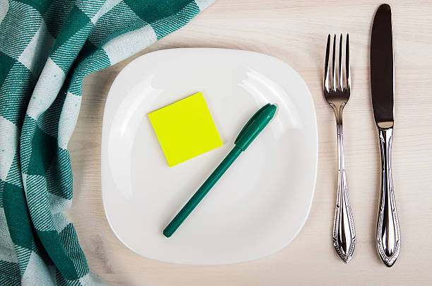 istock Empty dish, knife and fork and green napkin 473834228