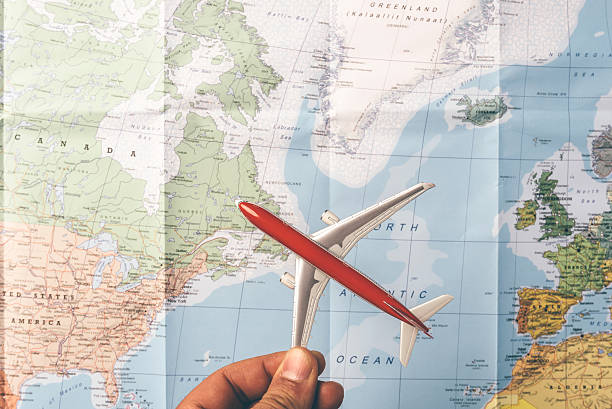 istock Travelling the world concept with a plain flying over map 473834288