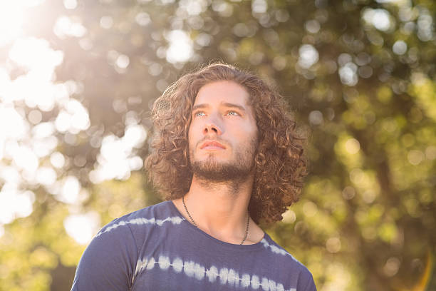 istock Handsome hipster in the park 473839140