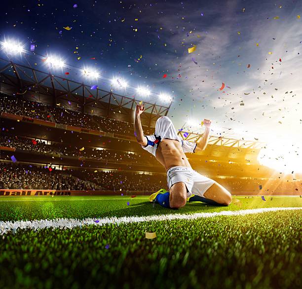 istock Soccer player celebrating his victory at sunset 473842368