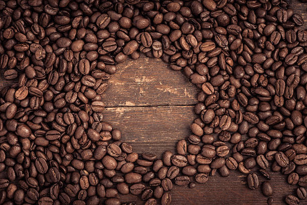 istock Roasted coffee beans on a rustic old wooden table 473843800
