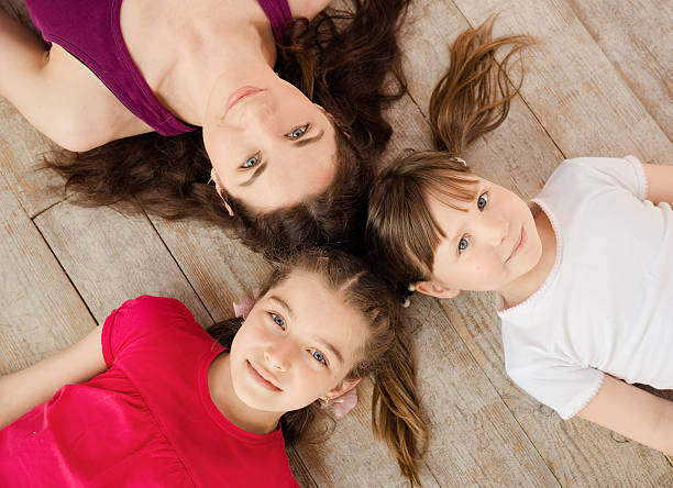 istock Young mother and daughter lying on the floor 473843910
