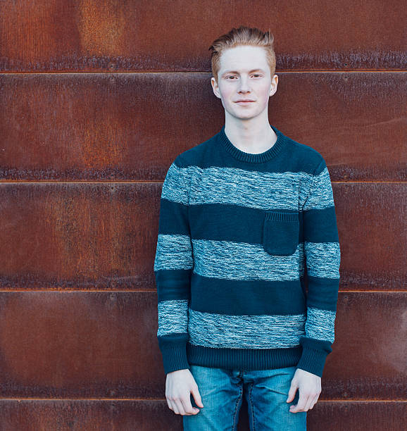 istock Young redhead man in a sweater and jeans 473846794