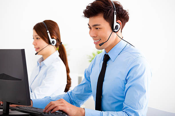 istock smiling business man and woman with headset working in office 473846964