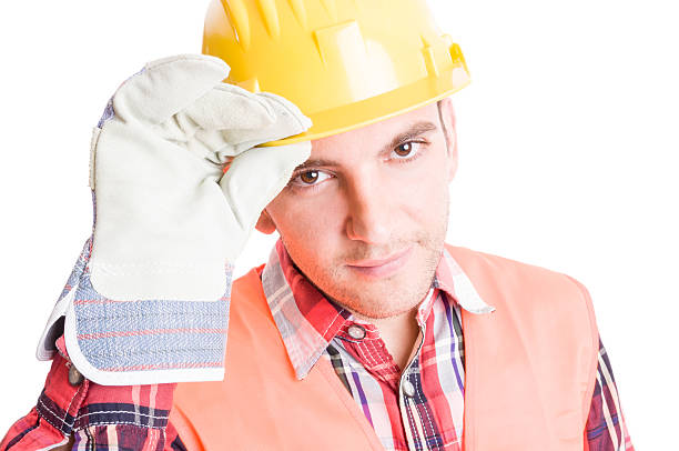 istock House builder geeting by touching his helmet 473850482
