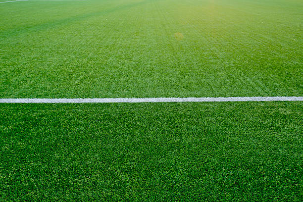 istock Straight white chalk line marking on grass background. 473850848