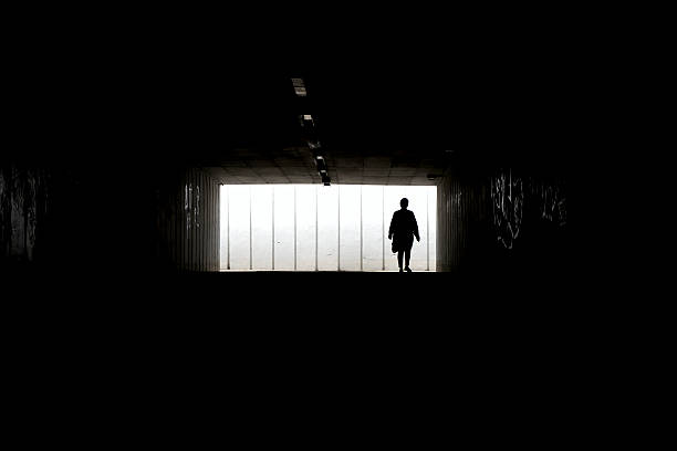 istock Silhouette of a woman walking alone 473857306