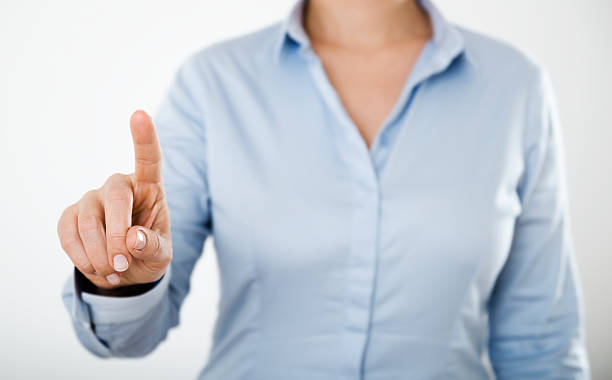 istock Woman holding up her index finger to touch something 473862180
