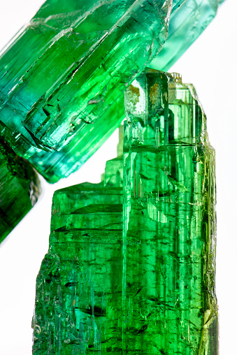 Raw tourmaline crystal with all I shades of natural green and texture