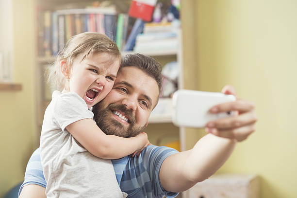 istock Father and daughter taking a selfie together 473862404