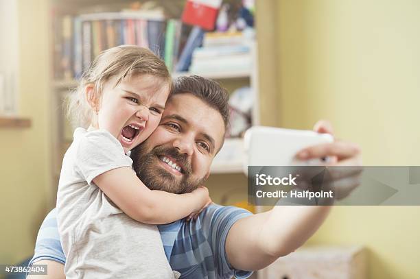 Father And Daughter Taking A Selfie Together Stock Photo - Download Image Now - 2015, Adult, Beard