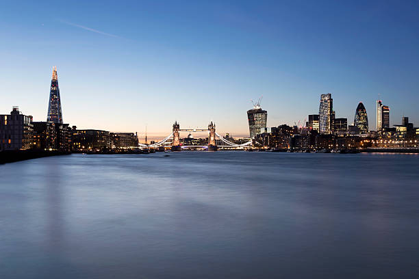 London skyline The Shard Tower Bridge City of London dusk View of London's skyline with The Shard, Tower Bridge and City of London at dusk. london gherkin at night stock pictures, royalty-free photos & images