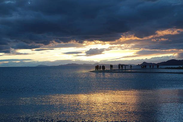 View of the sunset at Namtso lake with the human shadows and dramatic sky, Tibet, China