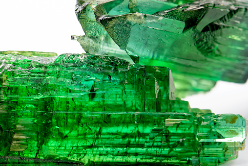 Raw tourmaline crystal with all I shades of natural green and texture