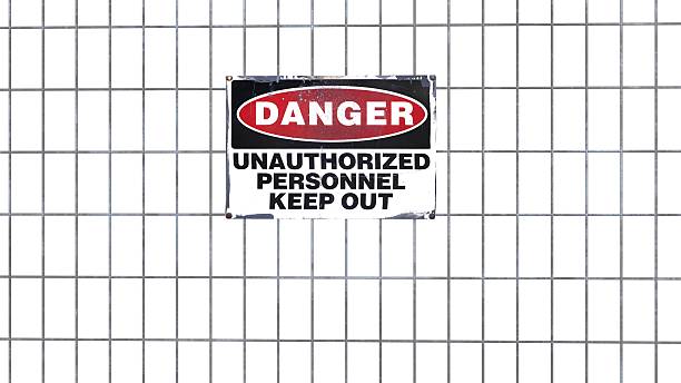 Danger sign on metal fence Danger sign on metal fence, unauthorized personnel keep out rusty fence stock pictures, royalty-free photos & images