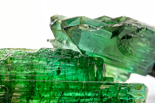 Raw tourmaline crystal with all I shades of natural green and texture