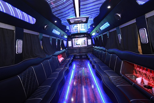 A big party bus filled with comfortable seats, and shiny bright floor for dancing and having fun.