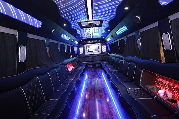 The Inside Of A Party Bus A big party bus filled with comfortable seats, and shiny bright floor for dancing and having fun. bus stock pictures, royalty-free photos & images