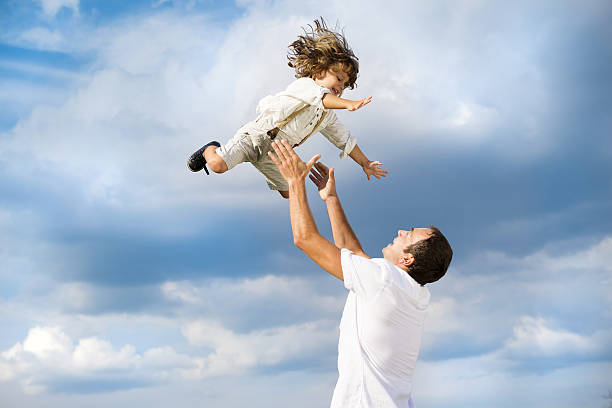 istock A father throwing his son up in the air 473873579