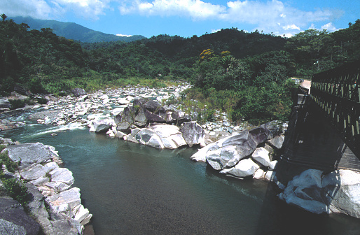 Rio Cangrejal or river and and old bridge in Pico Bonito National Park Atlantida Honduras showing the devastating bank erosion that occurred during Hurricane Mitch back in 1998