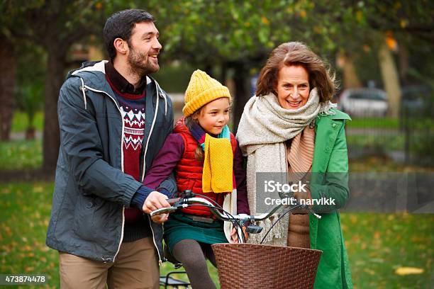 Grandmother With Father And Daughter Walking Together In The Park Stock Photo - Download Image Now