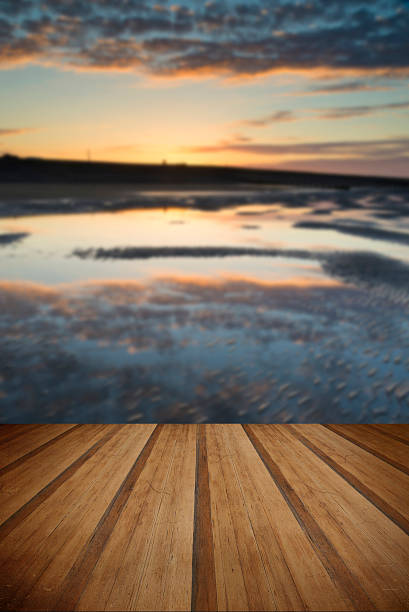 istock Vibrant sunrise landscape reflected in low tide water on beach 473876852